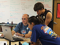 Mr. Reif answers questions with help of his laptop